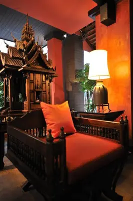 a bedroom with a bed with a lamp on a table at Siralanna Hotel in Patong Beach