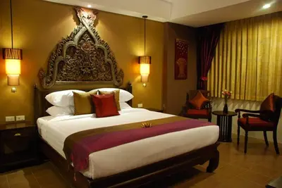 a bedroom with a large bed in a room at Siralanna Hotel in Patong Beach