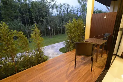 a balcony with a table and a chair on a deck at Aonang Glory Resort in Ao Nang Beach