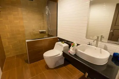 a bathroom with a toilet and a sink at Aonang Glory Resort in Ao Nang Beach