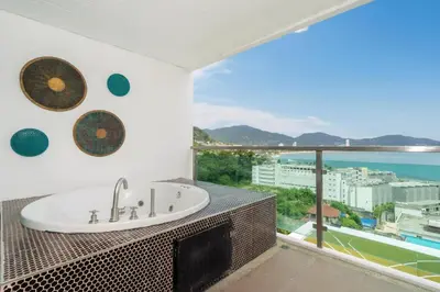 a bathroom with a sink and a view of the ocean at Private sea view apartment with jacuzzi at Baycliff in Patong Beach