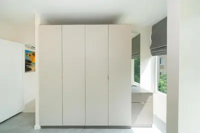 a room with white cabinets in a house at Private sea view apartment with jacuzzi at Baycliff in Patong Beach