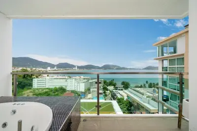 a balcony with a tub and a view of the ocean at Private sea view apartment with jacuzzi at Baycliff in Patong Beach