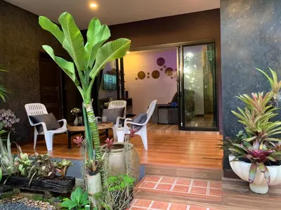 a lobby with a lot of plants and chairs at Smile Home Krabi Klong Moung Beach in Klong Muang Beach
