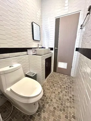 a white bathroom with a toilet and a sink at Smile Home Krabi Klong Moung Beach in Klong Muang Beach