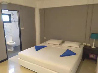 a bedroom with two blue pillows on a bed at Phi Phi Inn in Phi Phi Don