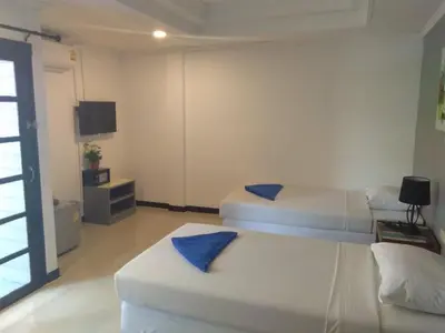 a bedroom with two beds with blue pillows on them at Phi Phi Inn in Phi Phi Don