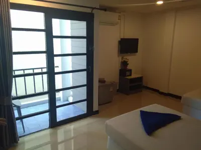 a room with a sliding glass door with a television at Phi Phi Inn in Phi Phi Don