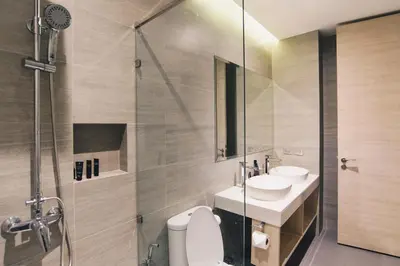 a bathroom with a toilet and a sink and a shower at Searocco Phuket in Patong Beach
