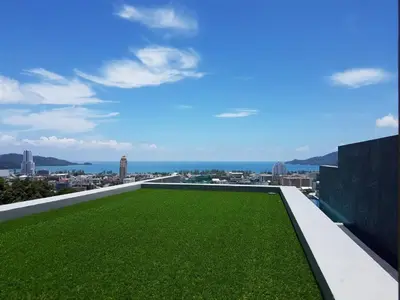 a green lawn on the roof of a building at Searocco Phuket in Patong Beach