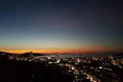 a view of a city at night at Searocco Phuket in Patong Beach