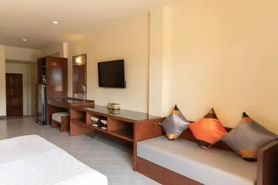 a hotel room with a couch with pillows on it at Park 38 Hotel - SHA Plus in Phuket Town