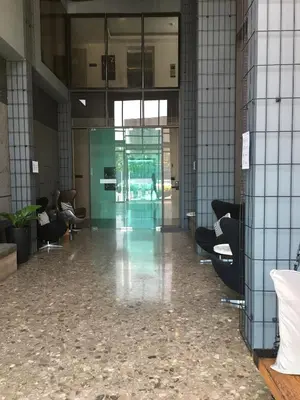 an empty lobby with chairs and a glass door at D-condo mine in Kathu