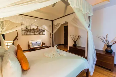 a bedroom with a white bed with a canopy at Tulip Pool Villa Luxurious Villa Escape Awaits in Nai Harn Beach