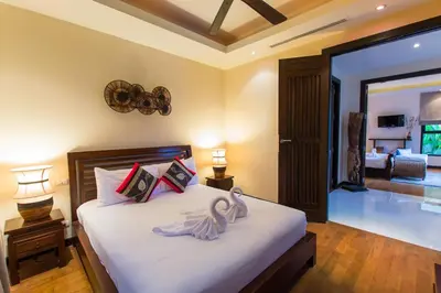 a bedroom with a bed with two swans on it at Tulip Pool Villa Luxurious Villa Escape Awaits in Nai Harn Beach