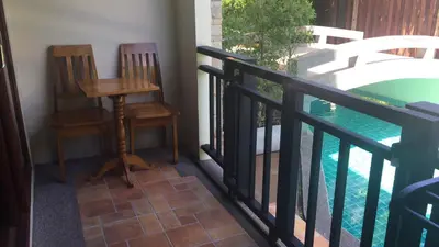 two chairs and a table on a balcony at JJ Residence in Phi Phi Don