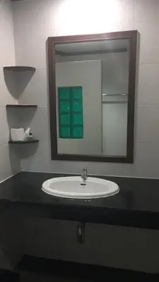 a bathroom with a sink and a mirror at JJ Residence in Phi Phi Don