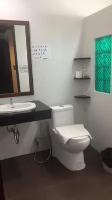 a bathroom with a white toilet and a sink at JJ Residence in Phi Phi Don