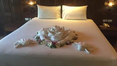 a bed with someones wedding dress and shoes on it at JJ Residence in Phi Phi Don