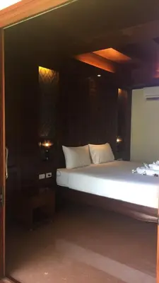 a large bed with white pillows in a room at JJ Residence in Phi Phi Don