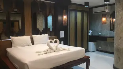 two swans made out of towels on a bed at JJ Bungalow in Phi Phi Don