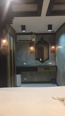 a room with a mirror and lights on a wall at JJ Bungalow in Phi Phi Don