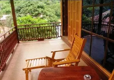 a porch with a rocking chair on a balcony at JJ Bungalow in Phi Phi Don