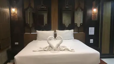 a bed with a heart made out of towels at JJ Bungalow in Phi Phi Don