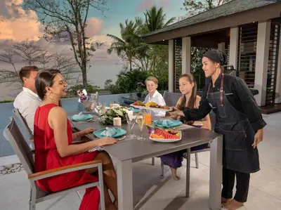 a group of people sitting around a table eating food at Naam Sawan in Ban Pa Khlok