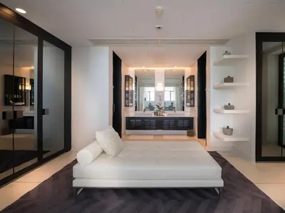 a white bed in a room with a bathroom at Naam Sawan in Ban Pa Khlok