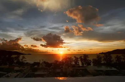 a view of a sunset from the balcony of a resort at PATONG TOWER SEA VIEW 3 BEDROOMs in Patong Beach