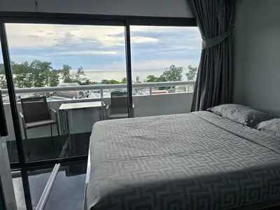 a bedroom with a bed and a balcony at PATONG TOWER SEA VIEW 3 BEDROOMs in Patong Beach