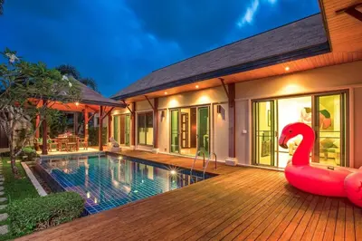 a house with a pool and a inflatable swan on the deck at VILLA BUTON Private Pool Nai Harn beach in Nai Harn Beach