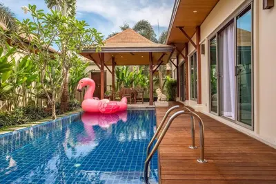 a pool with a pink inflatable flamingo in a house at VILLA BUTON Private Pool Nai Harn beach in Nai Harn Beach