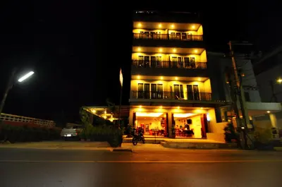 a building with yellow lights on it at night at Choophorn House in Kata Beach