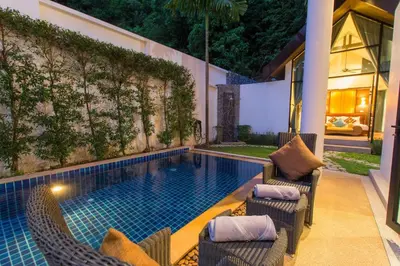 a swimming pool with chairs next to a house at Hidden Pool Villa A Hidden Haven Just For You in Rawai Beach