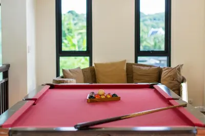 a red pool table with a bowl of fruit on it at Hidden Pool Villa A Hidden Haven Just For You in Rawai Beach