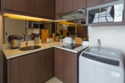 a small kitchen with a sink and a microwave at The Aristo by Holy Cow, 2-BR loft, 90 m2, pool view in Surin Beach