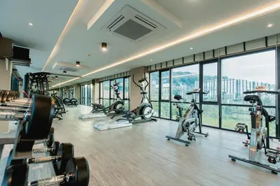 a gym with a bunch of treadmills and ellipticals at The Aristo by Holy Cow, 2-BR loft, 90 m2, pool view in Surin Beach