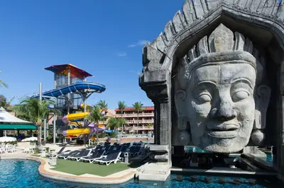 a large statue of a face in the pool at a resort at Phuket Orchid Resort and Spa in Karon Beach