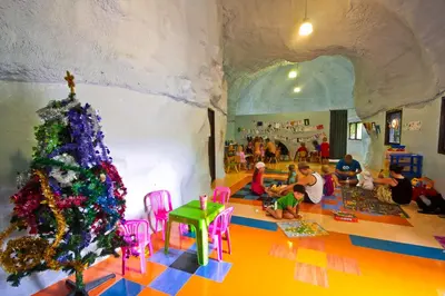 a room with a christmas tree and a group of children at Phuket Orchid Resort and Spa in Karon Beach