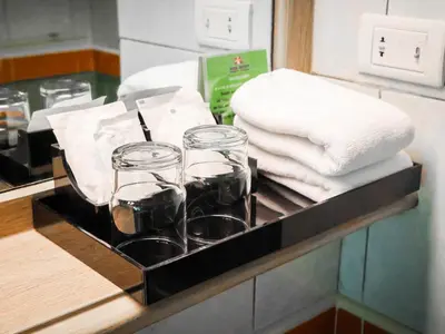 a tray with glasses and napkins on a counter at Phuket Orchid Resort and Spa in Karon Beach
