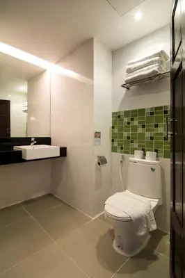 a bathroom with a toilet and a sink at Baan Karon Resort in Karon Beach