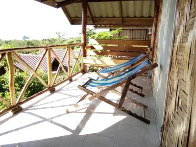 a pair of chairs on the porch of a house at Tabeak View Point in Ko Yao Noi