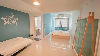 a room with two beds and a ladder in it at Turtle Rooms in Bang Tao Beach