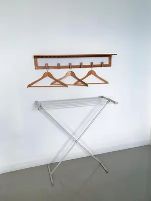 a shelf in a room with a white wall at Turtle Rooms in Bang Tao Beach
