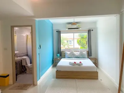 a bedroom with a bed with two stuffed animals on it at Turtle Rooms in Bang Tao Beach