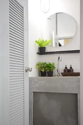a bathroom with a sink and a mirror at Hugger Hostel in Phuket Town