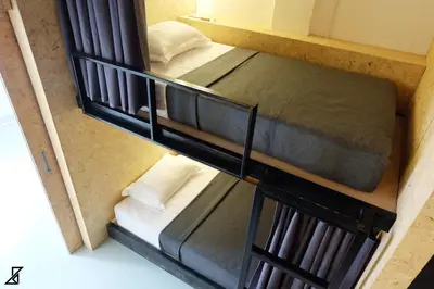 two bunk beds in a small room with at Hugger Hostel in Phuket Town