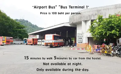 a group of buses parked in front of a bus terminal at Hugger Hostel in Phuket Town